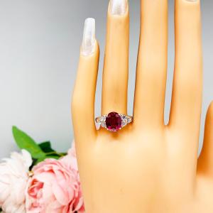 Lab Created Ruby Oval Ring Round CZ Accented Sterling Silver