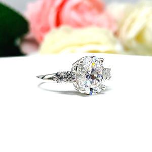 Oval Cubic Zirconia with Four Round Accents Engagement Ring