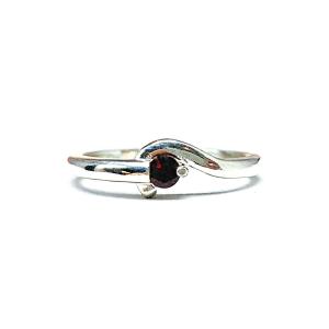 A sterling silver round gemstone bypass ring with a thin band. The ring is set with a 3mm round Mozambique garnet gemstone. The modern setting design curves around the gemstone. The ring is facing toward the back and is set against a white background.