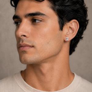 A close-up of a man wearing an 8x6mm white sapphire emerald-cut stud earring. Model image for size and styling reference — not a photo of the actual earrings.