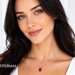 A woman wearing a 10x8mm oval lab ruby sterling silver 6-prong pendant necklace. Model image for size and styling reference — not a photo of the actual necklace.