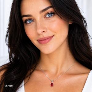 A woman wearing a 9x7mm oval lab ruby sterling silver 6-prong pendant necklace. Model image for size and styling reference — not a photo of the actual necklace.