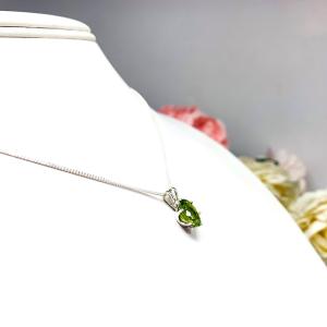 Bright neon green 9×7 mm oval apatite gemstone in a sterling silver six‑prong pendant, suspended from a delicate chain and displayed on a white background.