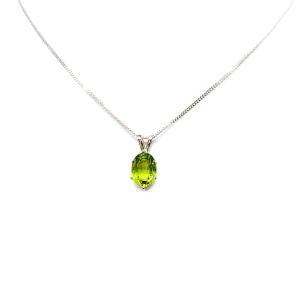 Bright neon green 9×7 mm oval apatite gemstone in a sterling silver six‑prong pendant, suspended from a delicate chain and displayed on a white background.