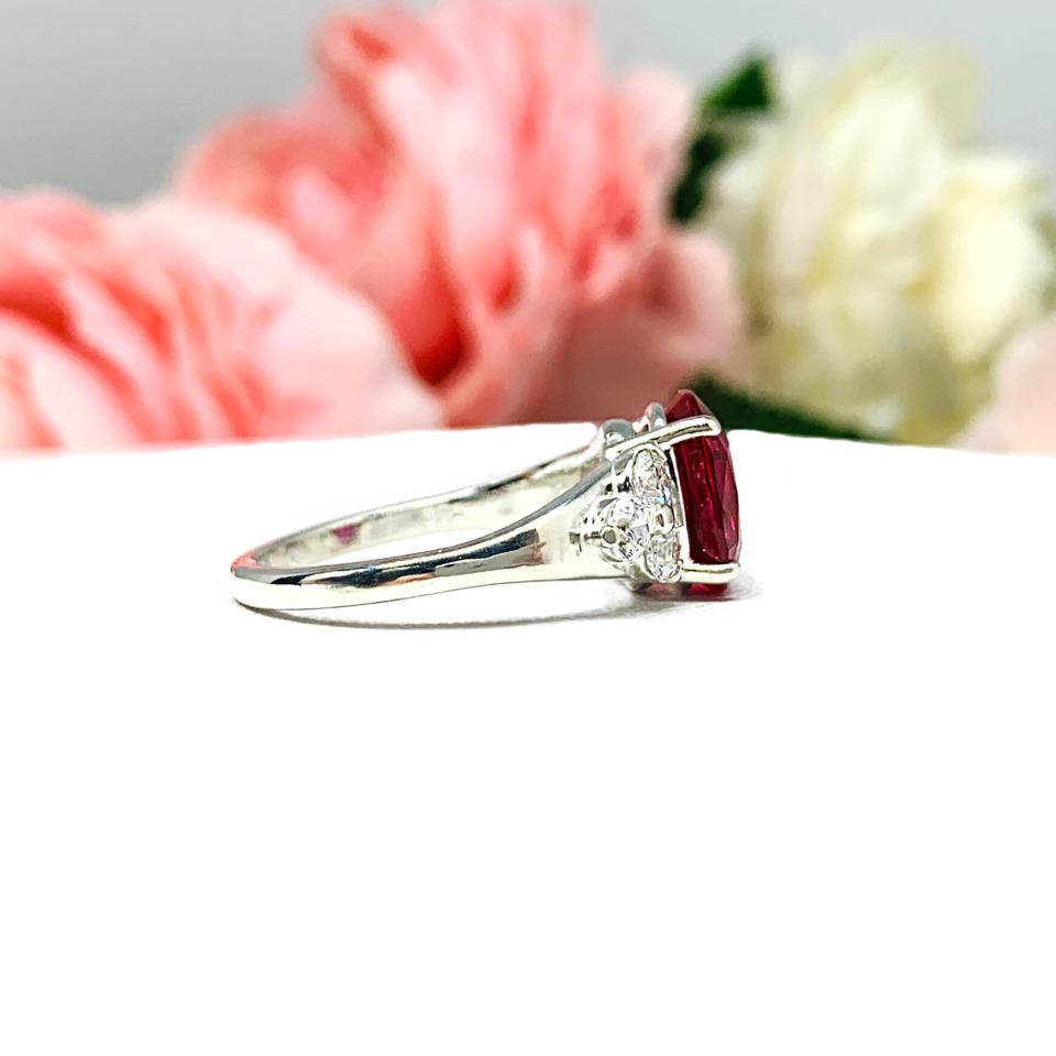 Lab Created Ruby Oval Ring Round CZ Accented Sterling Silver