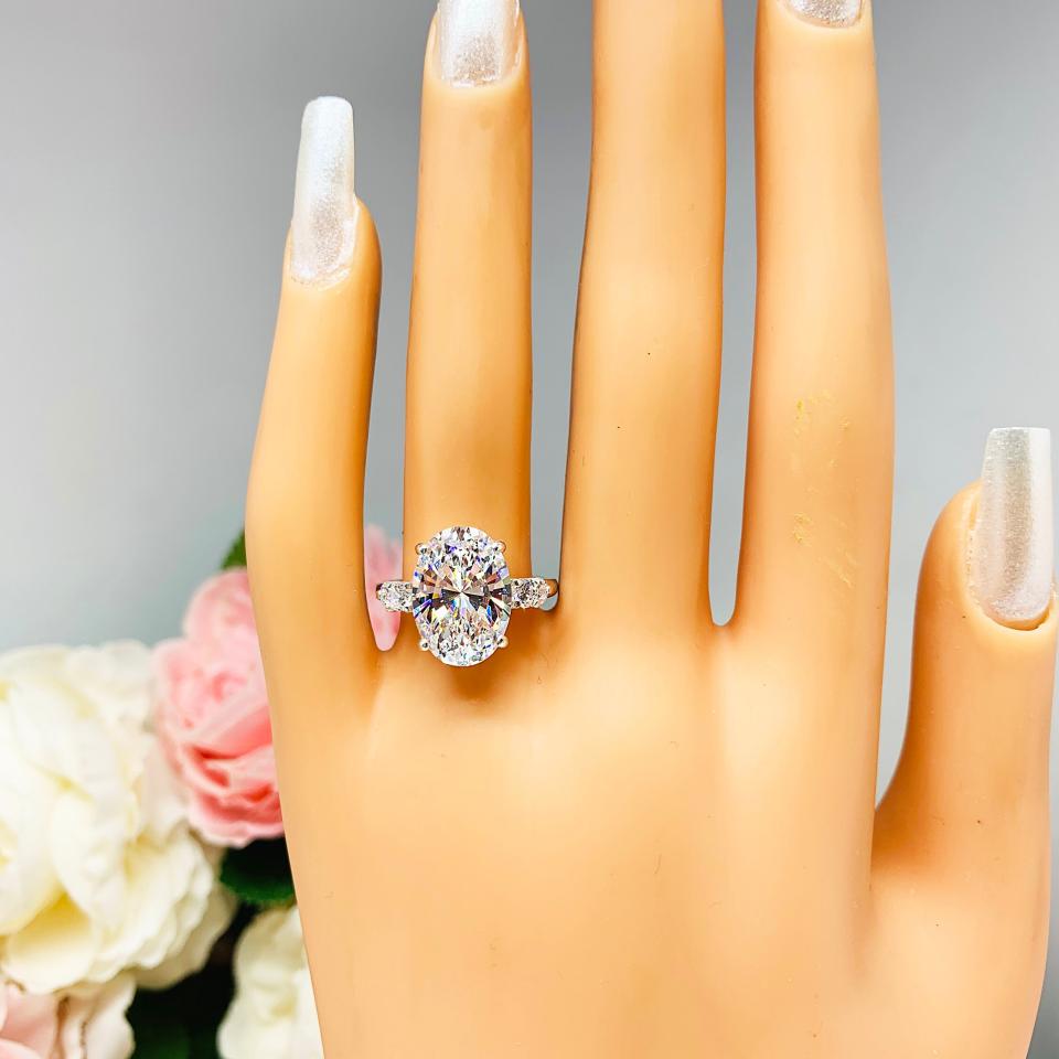 Oval Cubic Zirconia with Four Round Accents Engagement Ring