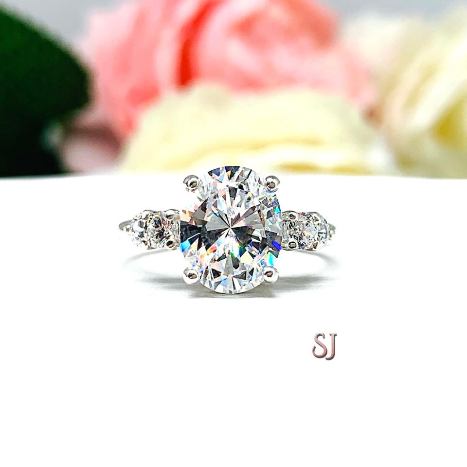 Oval Cubic Zirconia with Four Round Accents Engagement Ring