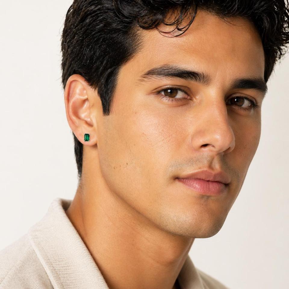 A man wearing 7x5mm emerald cut lab emerald sterling silver stud earrings. Model image for size and styling reference — not a photo of the actual earrings.