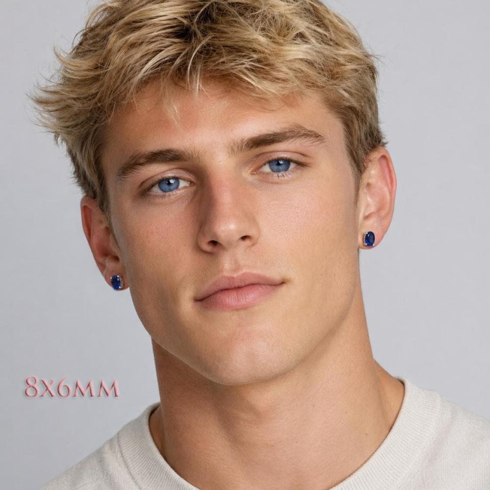 A man wearing 8x6mm oval lab blue sapphire oval sterling silver stud earrings. Model image for size and styling reference — not a photo of the actual earrings.