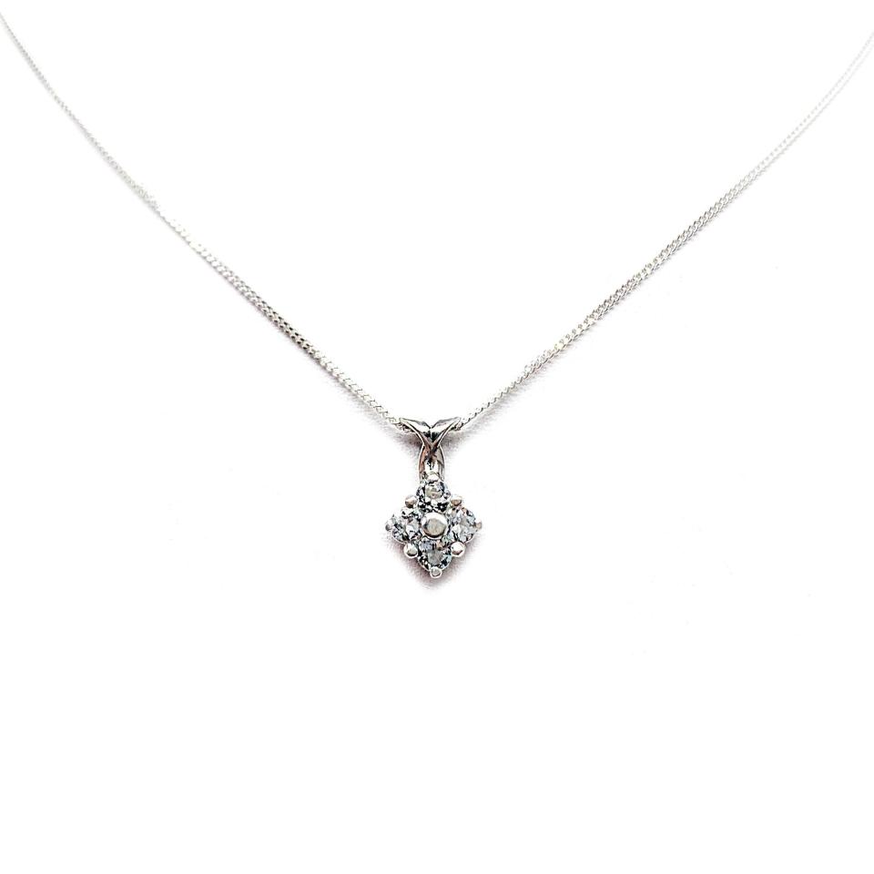 Sterling silver cluster pendant featuring four 3mm round light blue aquamarine gemstones and an elegant twist design bail. Suspended from a delicate sterling silver chain and set against a white background.
