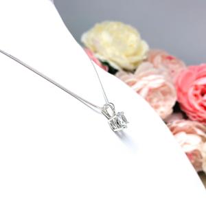 Sterling silver necklace featuring a round-cut white topaz pendant in a four-prong setting, suspended from a delicate silver chain. The natural gemstone is available in six size options and displays brilliant sparkle against a white background.