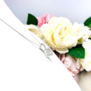 Sterling silver necklace with round-cut near colorless cubic zirconia pendant in a 4-prong basket setting with a lotus flower design.