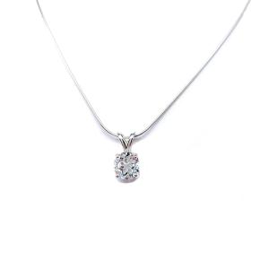 Sterling silver necklace featuring a round-cut white topaz pendant in a four-prong setting, suspended from a delicate silver chain. The natural gemstone is available in six size options and displays brilliant sparkle against a white background.