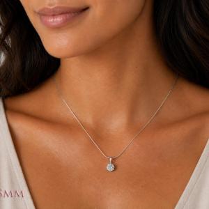 A woman wearing a 8mm round cz 3-prong sterling silver pendant necklace. Model image for size and styling reference — not a photo of the actual necklace.