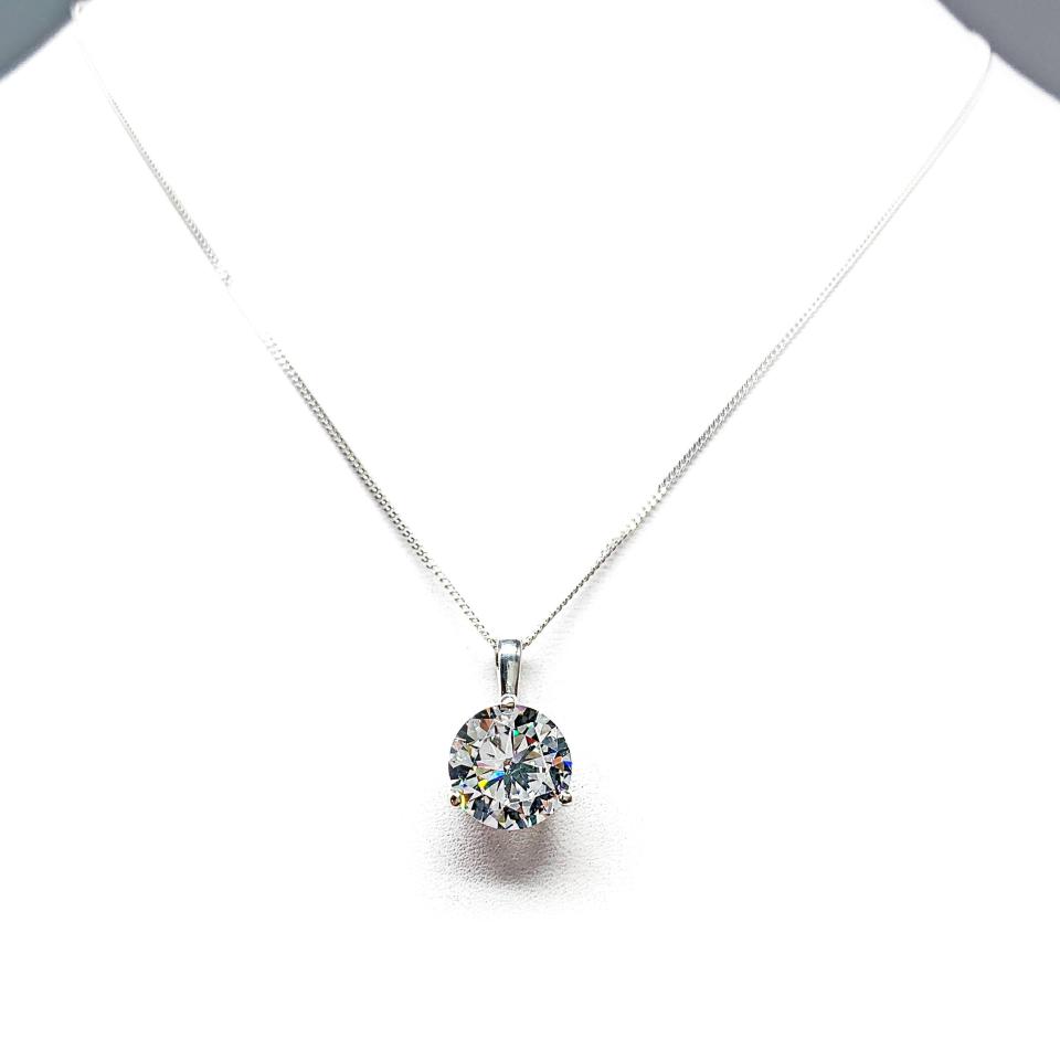 Sterling silver necklace with round-cut colorless cubic zirconia pendant in a 3-prong martini basket setting with a single bail, available in seven sizes.